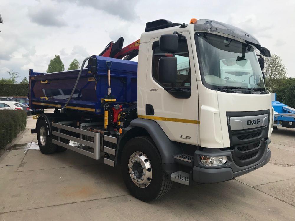 Black grab lorry with back up